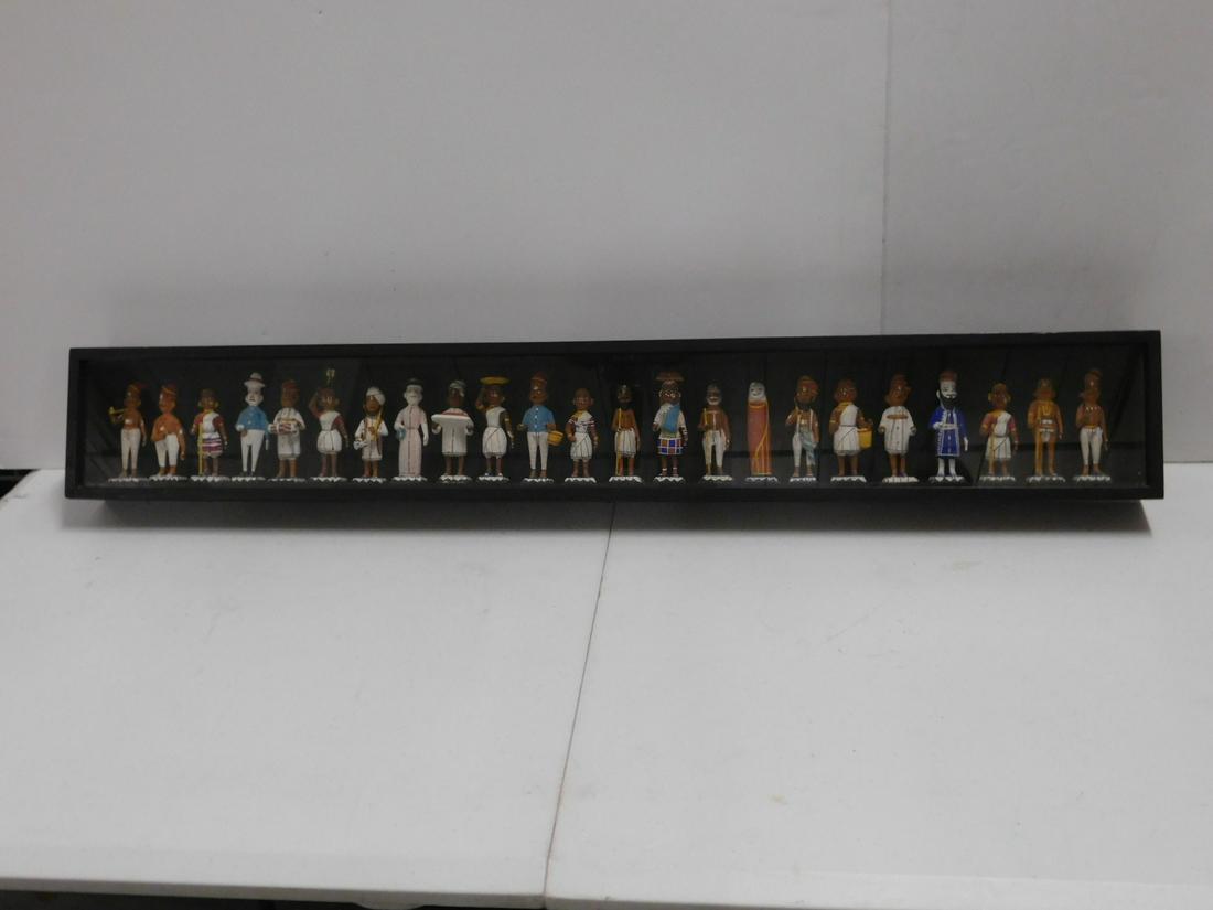 Shadow Box w/India Pottery Figures: Shadow Box w/India Pottery Figures, ebonized wood shadow box with glass front holds twenty-three polychromed standing terracotta pottery Indian costumed figures, 20th C, 37" x 2 3/4" x 5 1/2". CONDITI