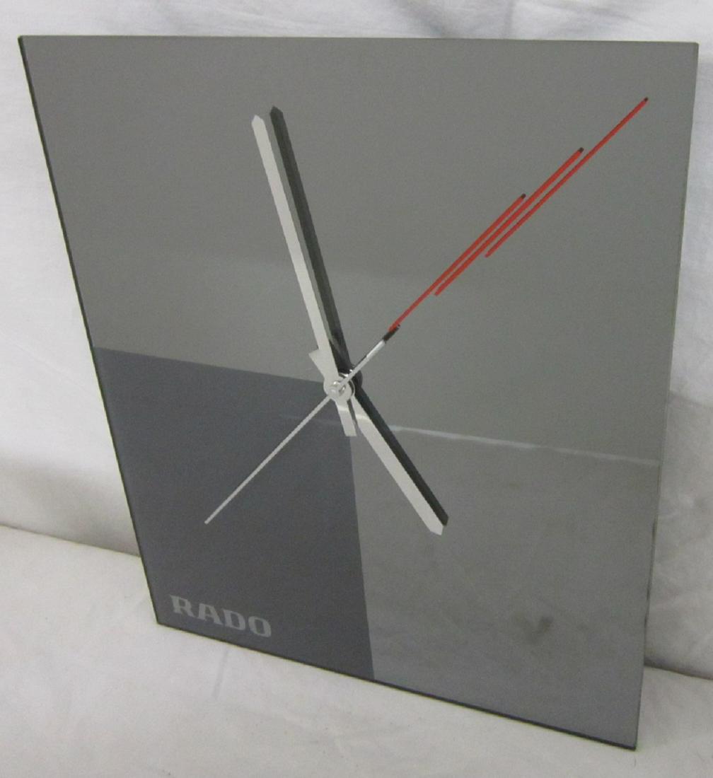Rado Store Clock: Rado Store Clock, two tone smoked mirror panel with red highlights and aluminum hands, W. Germany quartz movement, new in original shipping box, clock 12" x 14" x 1 1/2". CONDITION: New in box, curren
