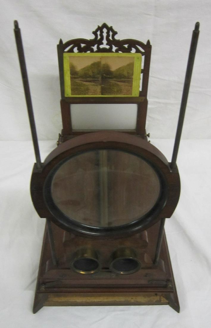 Table Top Stereopticon: Table Top Stereopticon, by American Optical Co. New York, walnut with reticulated panel, single large round magnifying glass, frosted glass panel, and twin brass eye viewing cups; brass adjustable fit
