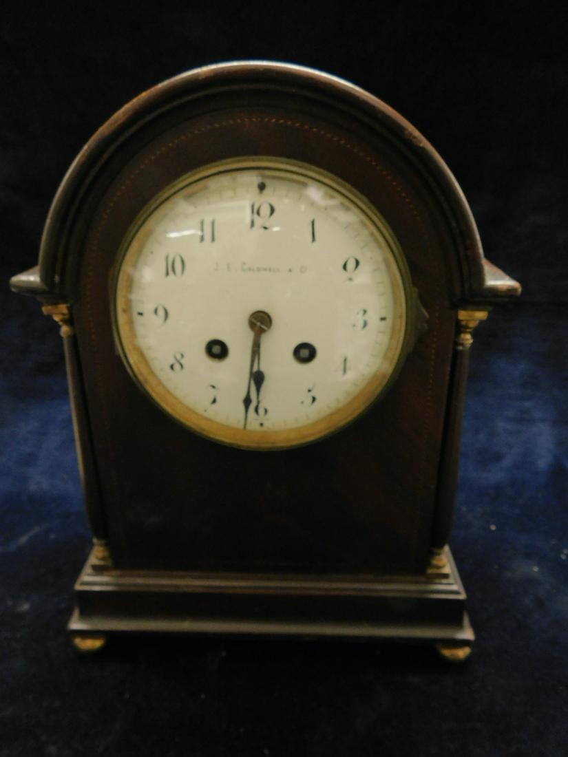 J.E. Caldwell & Co. Mantel Clock: J.E. Caldwell & Co. Mantel Clock, made in France G.B. & E. brass time and strike movements; mahogany domed case with rope inlay brass capitols and feet, early 20th c., 11 1/4"h. CONDITION: Areas of fi