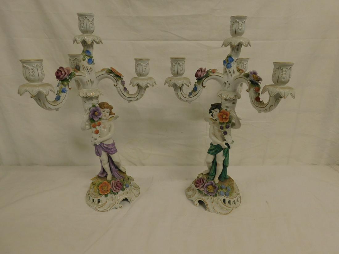 Pr Van Schierholz Porcelain Candelabra: Pair Van Schierholz Porcelain Candelabra, Germany, features putti holding horn of plenty; applied flowers; four candle light; in two parts, early 20th C, 18 3/4"h. CONDITION: Very fine, possibly but n