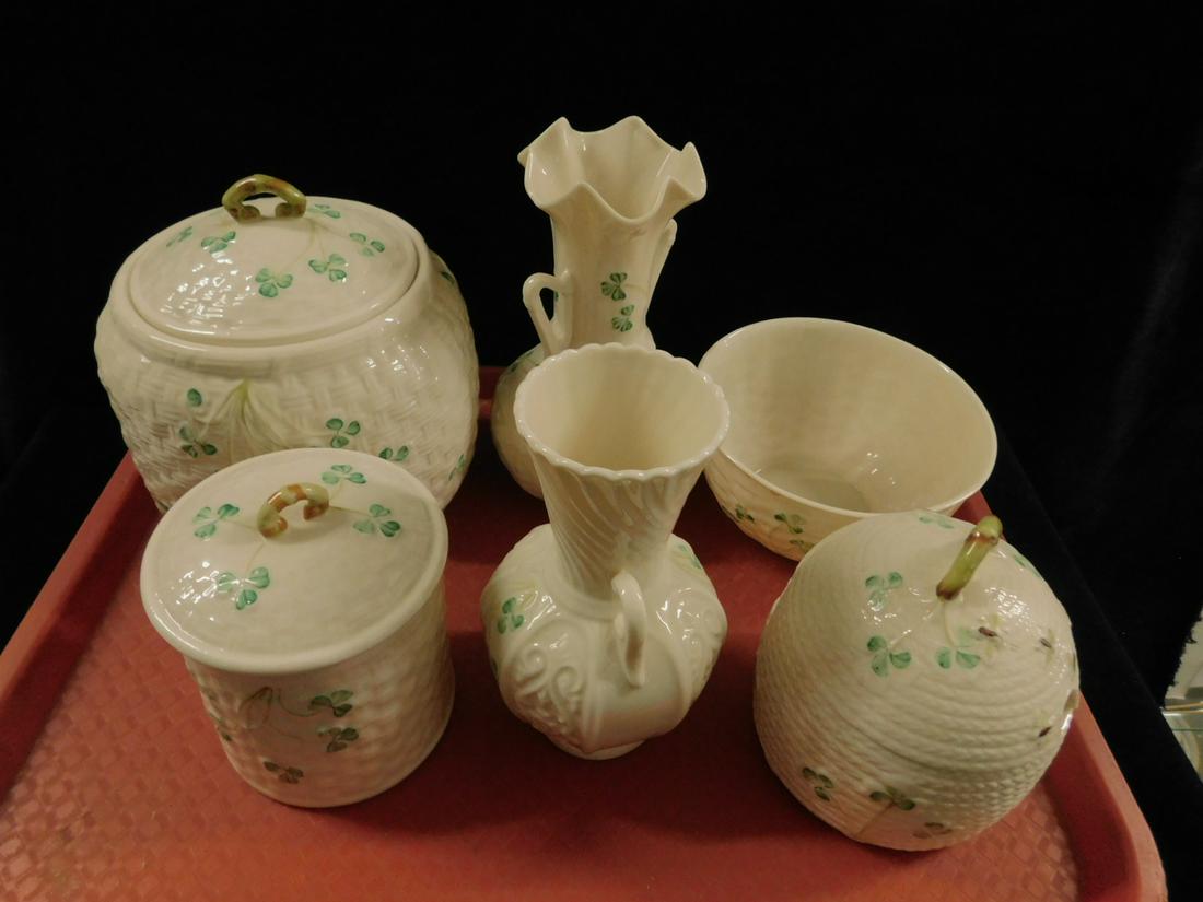 6 Belleek Porcelain Pieces: Six Belleek Porcelain Pieces includes: honey jar, biscuit jar, small covered jar, two vases and bowl, two gold and four green marks, 20th c. CONDITION: Very fine.