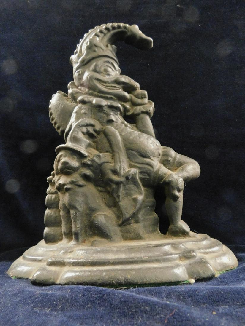 Antique "Punch" Door Stop: Antique "Punch" Door Stop, black painted cast iron, seated "Punch" figure, probably by Archibald Kendrick & Sons, circa late 19th c, approx 12"h. CONDITION: Very good condition with modest wear and li