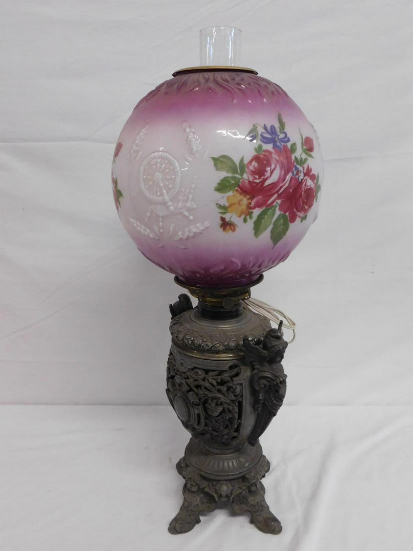 Gone With The Wind Fluid Lamp: Gone With The Wind Fluid Lamp, open work cast spelter metal font and base featuring winged maidens, Putti masks, scrolls and cartouches, painted glass ball shade with flowers and embossed spinning whe