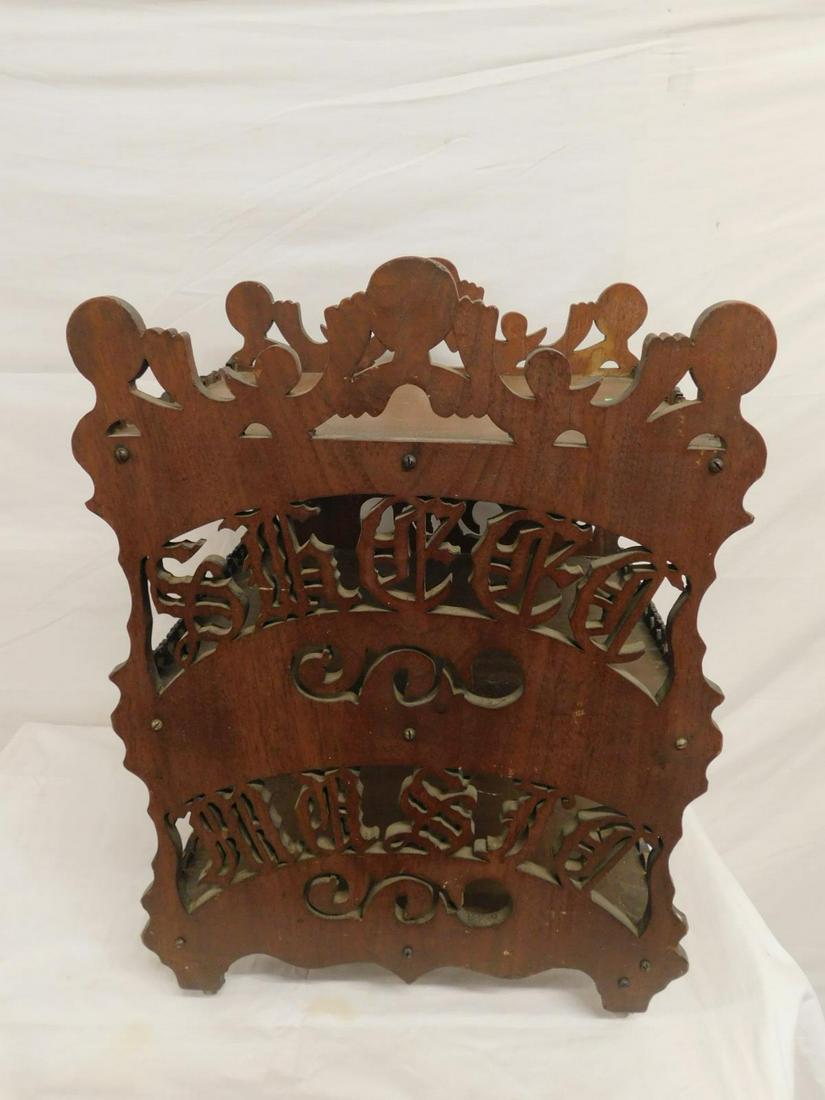 Tramp Art Sheet Music Stand: Tramp Art Sheet Music Stand, mahogany, three shelves supported by ornate reticulated sides with "Sheet Music', lettering and scrolls, casters, 19th / 20th C, 17" x 14 1/2" x 22 1/2". CONDITION: Some f