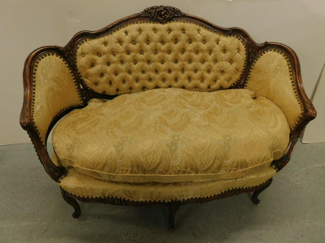 Louis XV Style Love Seat: Louis XV Style Love Seat, mahogany finished frame with floral and scroll carved serpentine back, acanthus carved arms and knees, cabriole legs with scroll feet, partially tufted gold brocade upholster