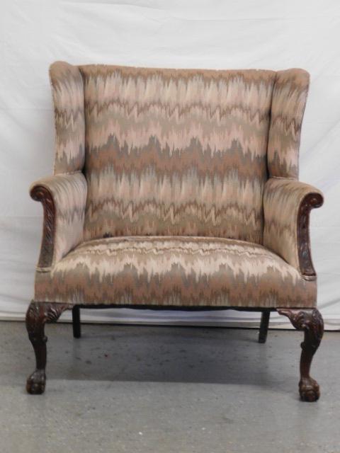 Chippendale Style Wing Chair: Chippendale Style Wing Chair, beige flame pattern cloth upholstery, over sized seat, mahogany carved cabriole legs with ball and claw feet, mid 20th C, 40"h. CONDITION: Used condition with moderate we