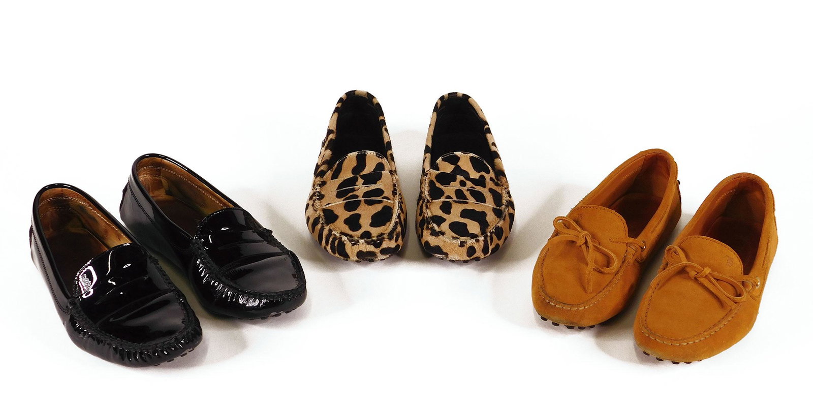 Tod’s: Three Pairs Women’s Gommino Driving Shoes: Three pairs Tod’s women’s Gommino driving shoes, comprised of one pair in light brown suede with a bow, size 36.5; one pair in black patent leather, size 6.5; and one pair in leopard print calf ha