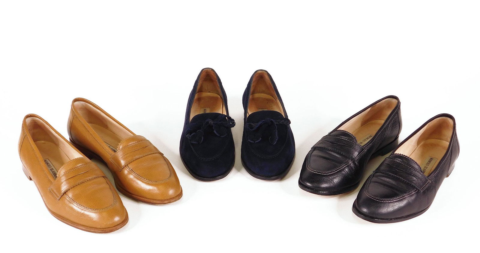 Manolo Blahnik: Three Pairs Women’s Loafers: Three pairs Manolo Blahnik women’s loafers, all size 37. Comprised of one pair “Genes” in camel color leather, one pair “Genes” in black leather with white stitching, and one pair “Kika”