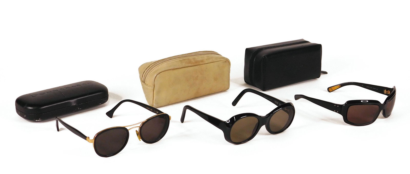 Bulgari, Paul Smith: Five Pairs Sunglasses: Two pairs sunglasses, comprised of one pair black Bulgari sunglasses with silver accents, in box with care cards; and one pair black Paul Smith sunglasses, in leather case. Along with two pairs black 