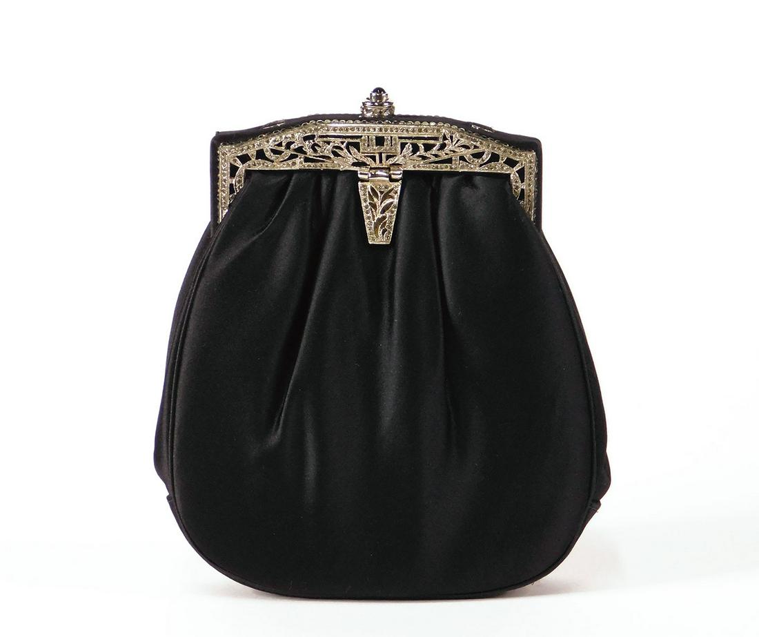 Judith Leiber Silk Clutch: A Judith Leiber black silk clutch with Art Deco embellishments (embedded with what are likely Swarovski crystals). Black silk interior, one open interior pocket. Includes compact mirror, integrated po
