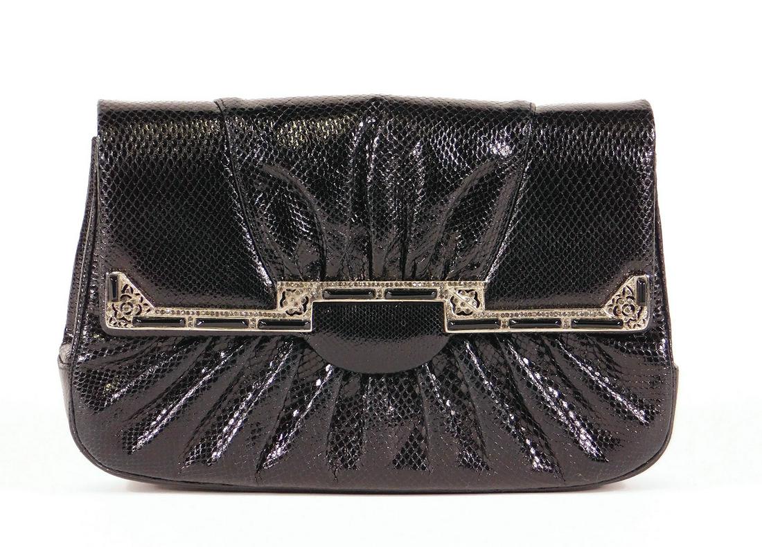 Judith Leiber Snakeskin Clutch: A Judith Leiber black snakeskin clutch with Art Deco embellishments. One open exterior pocket on the reverse, black silk interior, one open interior pocket, one zippered interior pocket. Includes bran