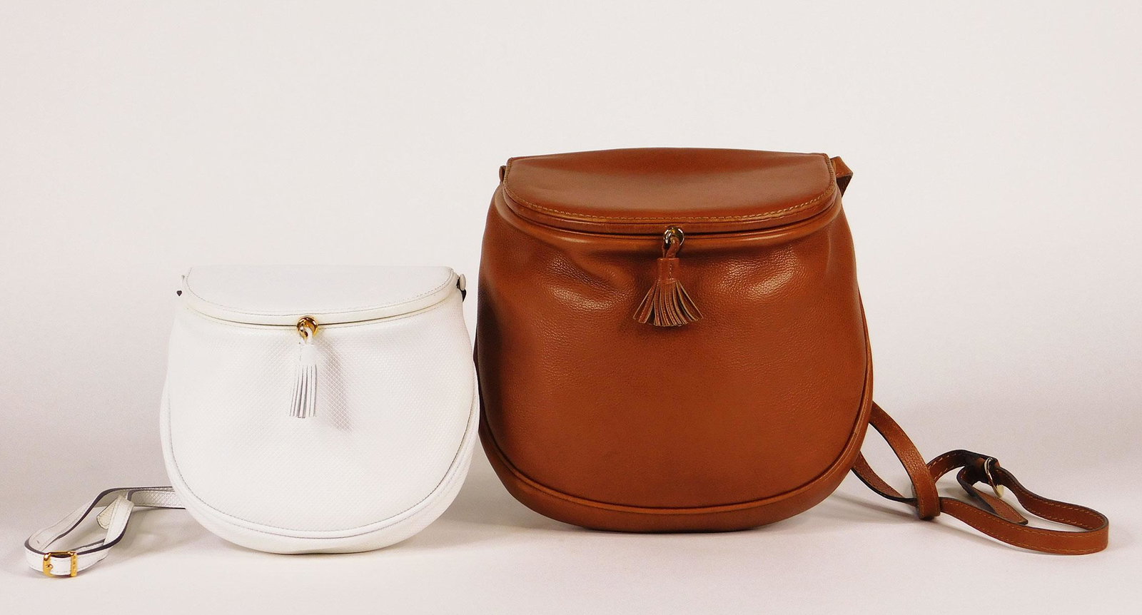 Bottega Veneta: Pair of Vintage Leather Saddle Bag: Two vintage Bottega Veneta leather saddle bags. The first a small white leather bag with an embossed diamond pattern and camel calfskin (or imitation) interior with one open pocket (this bag also has 