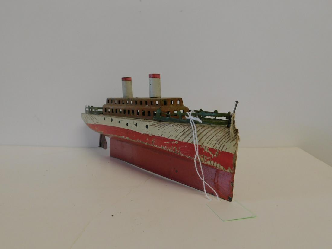 Vintage Wood & Pressed Tin Ship: Vintage Wood & Pressed Tin Ship, painted wood hull with metal keel and rudder, tin passenger compartment with front and back rails, two red and white tin stacks at top, 10 1/2" Condition; paint loss o