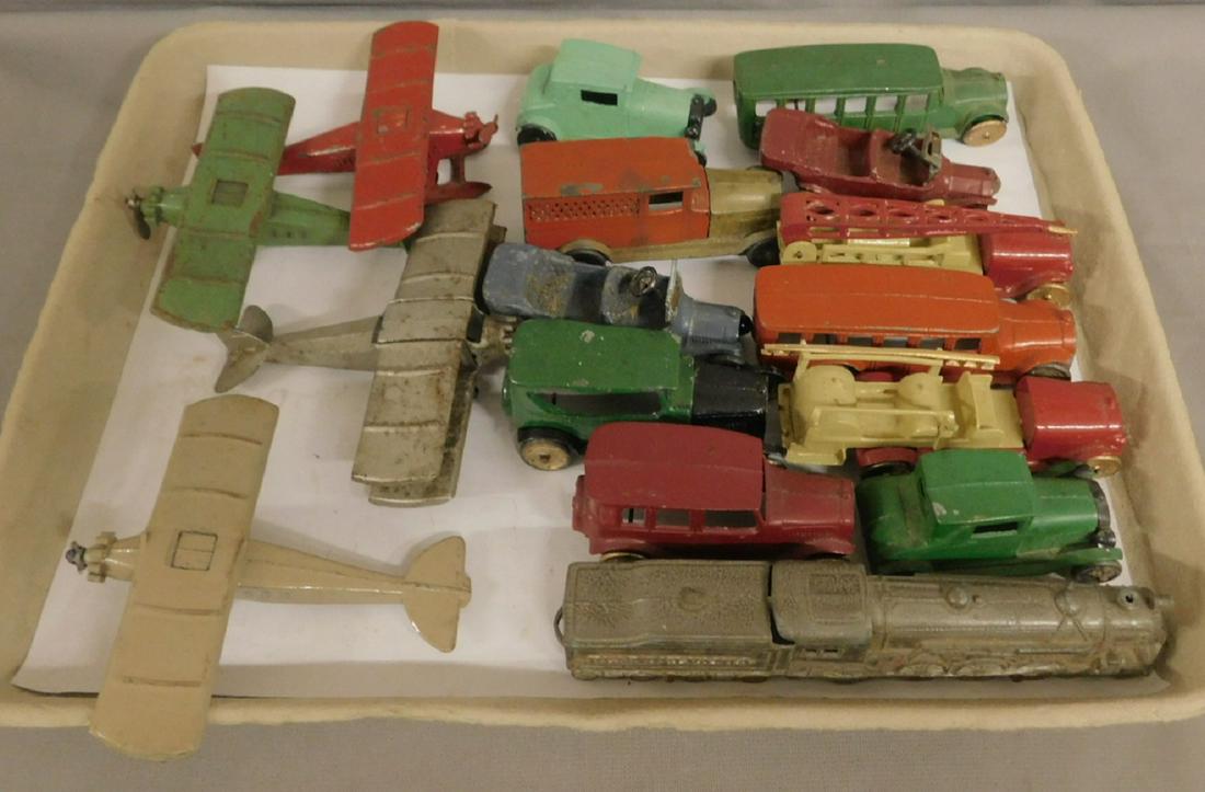 16 Cast Metal Tootsie Toys: Sixteen Cast Metal Tootsie Toys includes: eleven metal wheel, early 20th C, cars, trucks, buses, etc., from 2 1/2" to 3 1/2"l; one Pa. rubber wheels, 5 1/2" engine with tender, and four airplanes. CON