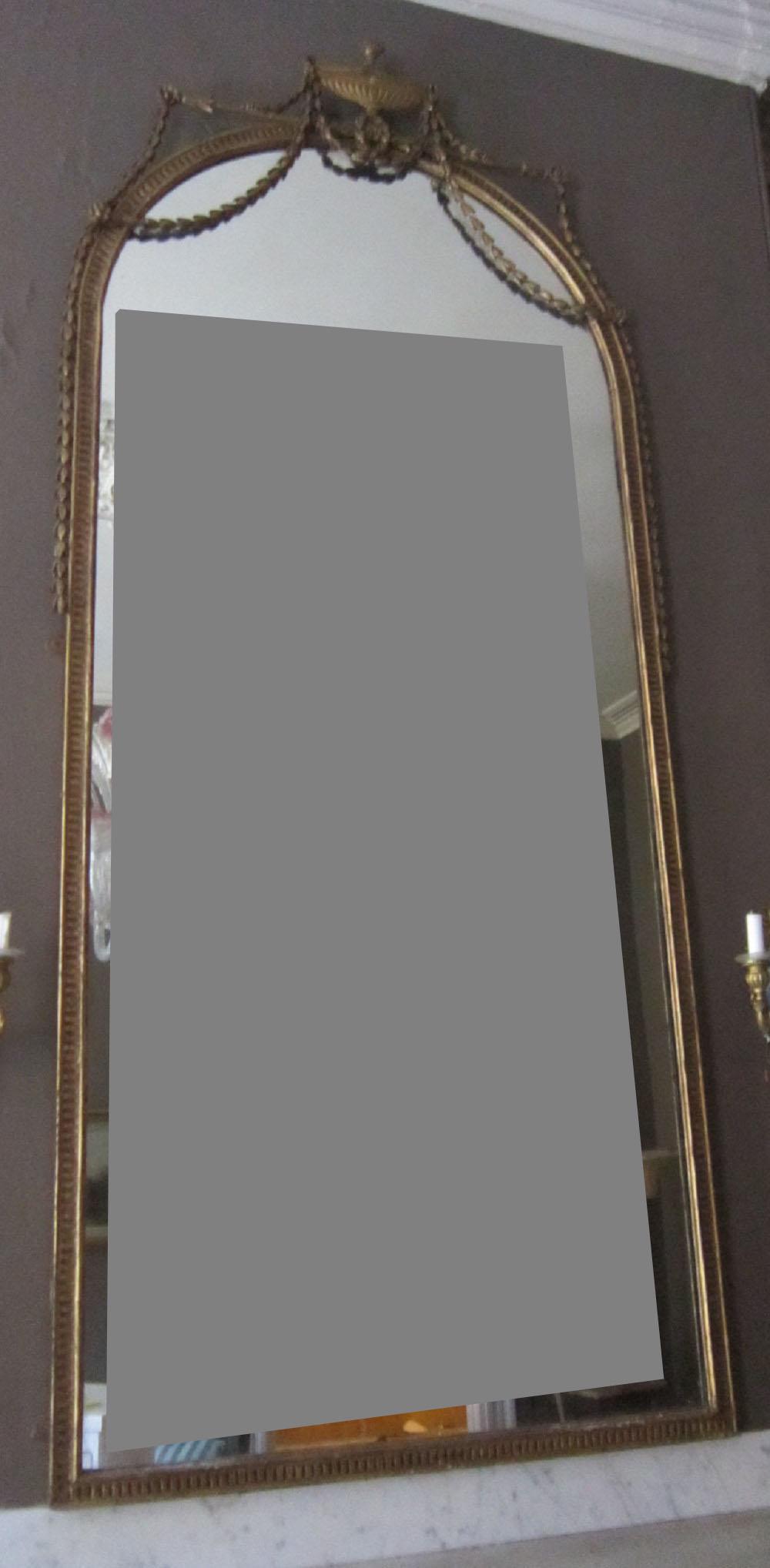 Federal Period Over Mantle Mirror: Federal Period Over Mantle Mirror, gilt with urn and bellflower garland crest, notched frame, 38" x 90", circa 1800. Condition; wear and light losses to gilt, some mirror spotting.