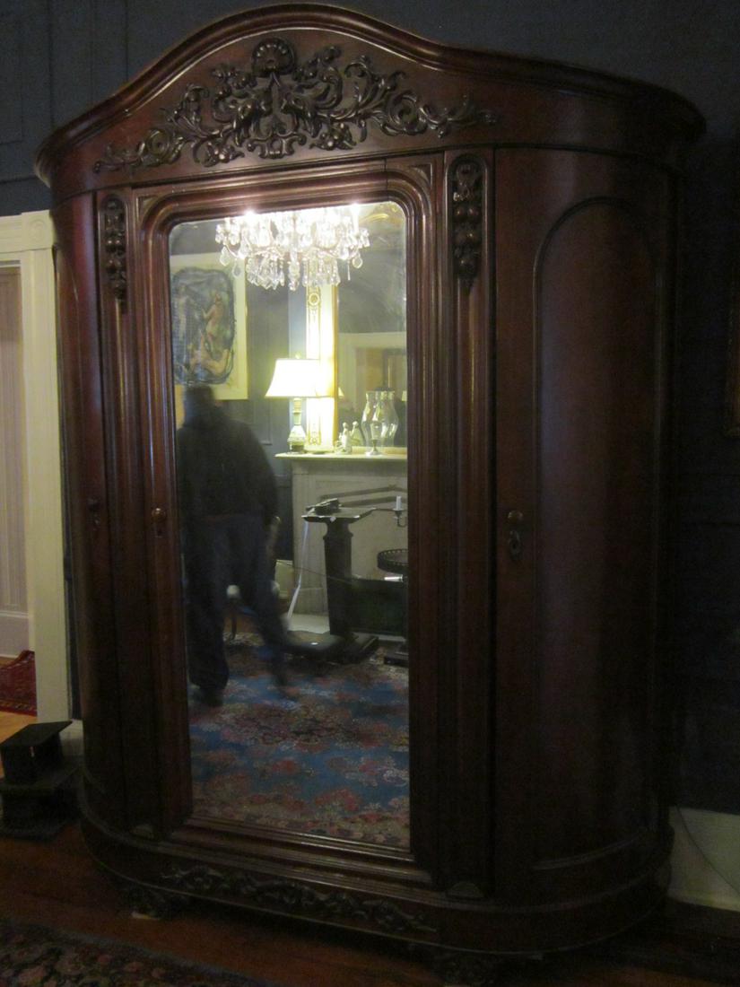 Rococo Revival Armour: Rococo Revival Armour, walnut, bow form high relief fruit and acanthus carvings, single mirrored center door, 2 blind side doors, 2 interior drawers, circa 1860's - 70's. 106" x 80" x 24" Condition; r