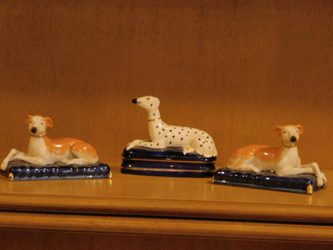 3 Staffordshire Style Porcelain Dogs: 3 Staffordshire Style Porcelain Dogs including; pair of dogs on pillows and Fitz and Floyd dog box, longest = 5". Condition; very fine