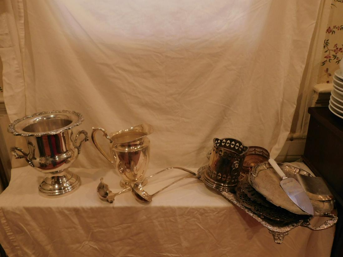Lot Silverplated Table ware: Lot Silverplated Table ware including; 20" divided tray, 10 1/2" champagne cooler, champagne castor, bottle holder with lion mask handles, 3 trivets (5 7/8" - 10 1/2" diam.), footed tray, water pitche