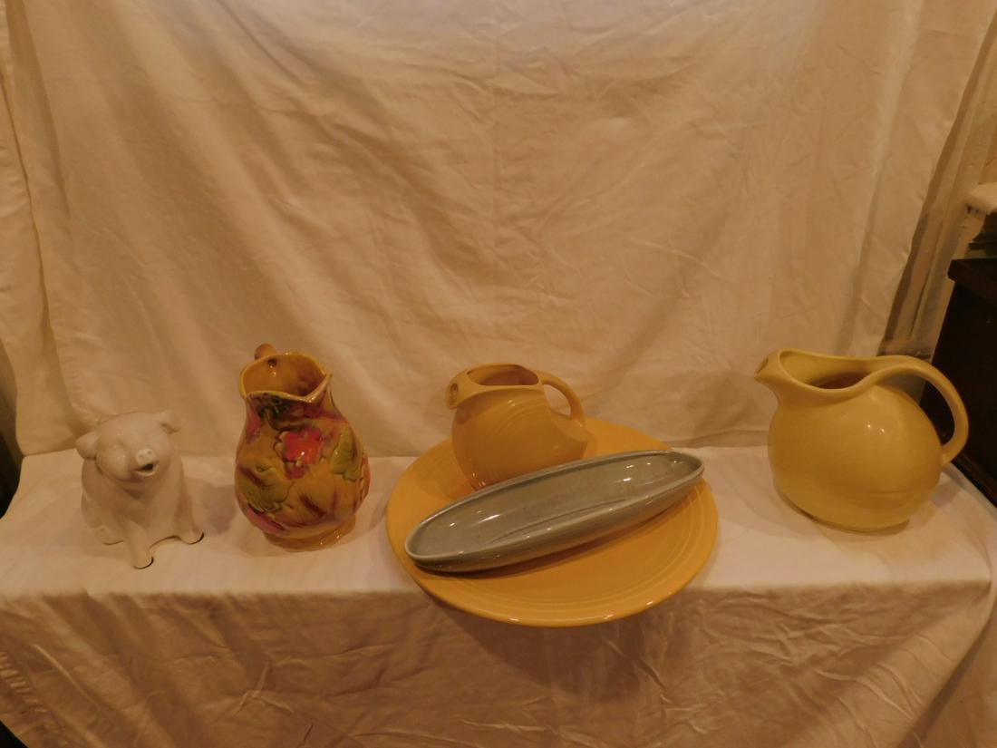 Pottery Grouping: Pottery Grouping including; Raymor California pottery, 13 1/2" celery, Fiesta 6" water pitcher and 14" charger, Marcreast 7 3/4" water pitcher, plus two unmarked "pig and leaf" Condition; very good