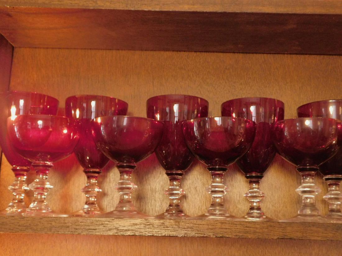 39 Ruby Glass Goblets: 39 Ruby Glass Goblets, clear glass stems including; (13) water glasses, 6", (13) Champagne, 4 1/2" and (13) Champagne, 3 1/2" Condition; very good