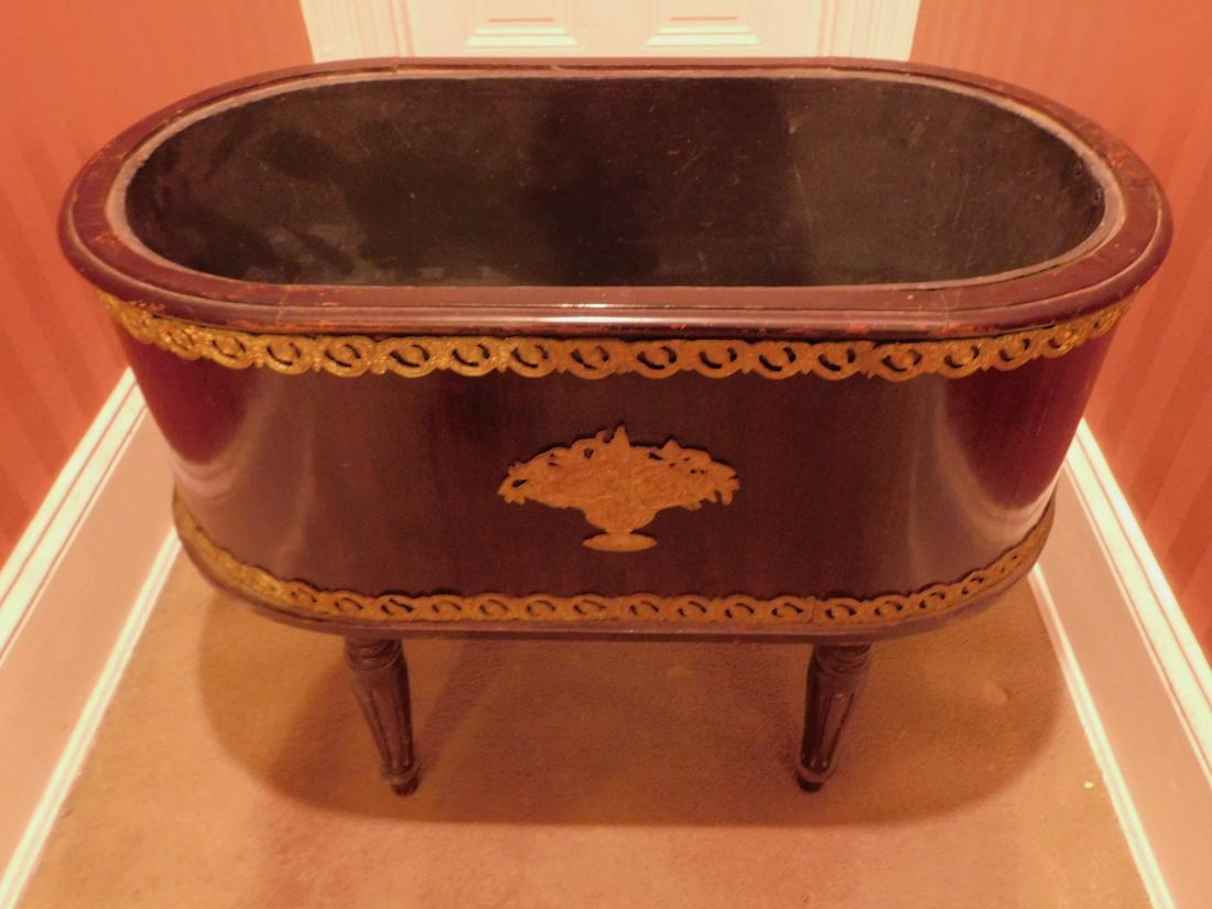 French Empire Style Cooler Tub: French Empire Style Cooler Tub, ebonized hard wood in oval form with tin liner, reeded turned legs and brass mounts, late 19th c. 19" x 35 1/2" x 25 1/2" Condition; areas of finish wear and scratches