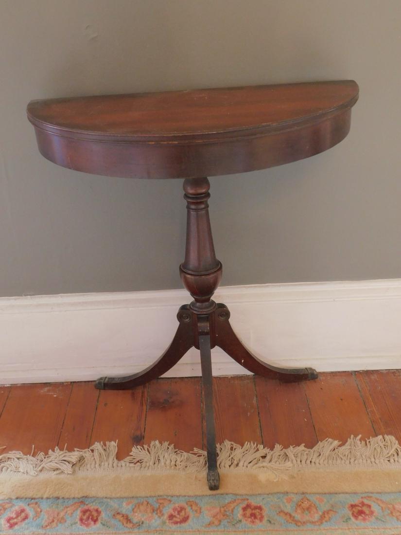 Demi Lune Console Table: Demi Lune Console Table, mahogany, Duncan Phyfe style, sabre legs with brass cap feet, 26" x 13" x 29 1/2" Condition; some minor surface scratching with normal wear