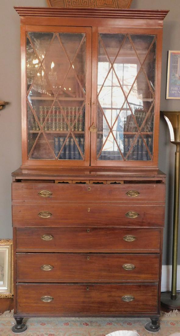 Sheraton Butlers Desk: Sheraton Butlers Desk, with bookcase top, two glazed glass doors over base with drop front butler's drawer having a fitted interior, again over three graduated beaded drawers with oval brasses, turned