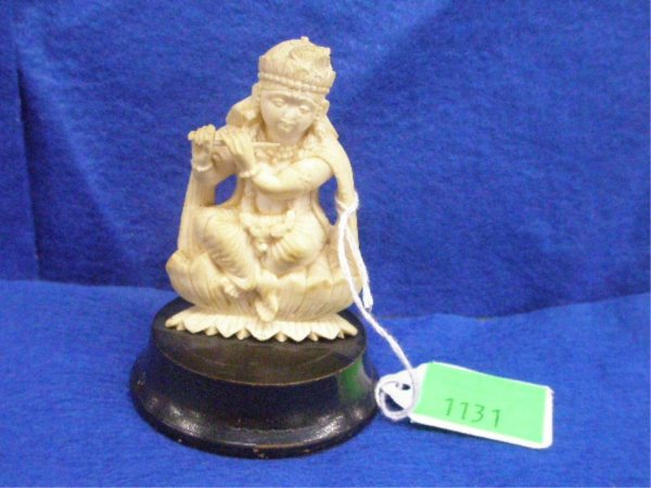 Ivory Buddhist Seated Deity With Flute: Ivory Buddhist Seated Deity With Flute on lotus blossom wood base, H 65 mm, early 20th c. [47]. No International Shipping