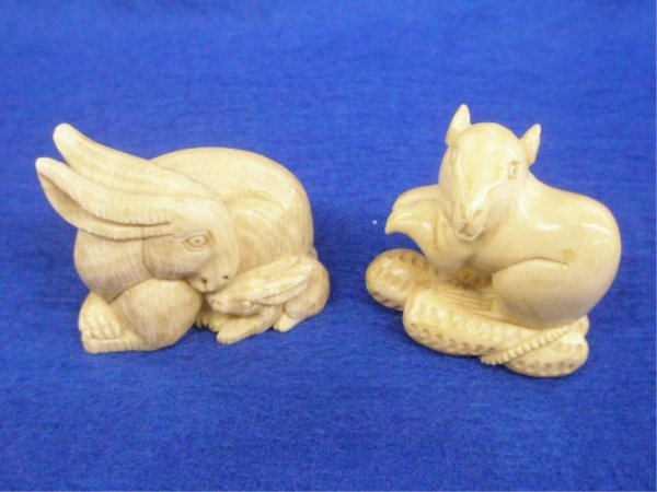 Two Ivory Netsuke's: Two Ivory Netsuke's, a squirrel with nuts H 38 mm & a mother & baby rabbit H 36 mm; both signed; 20th c. [7]. No International Shipping
