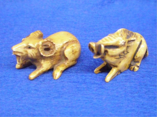 Two Ivory Netsuke's, Boar And Ram: Two Ivory Netsuke's, reclining (L 54 mm) Boar And reclining (L 47 mm) Ram. Both Signed; 20th c. [7]. No International Shipping