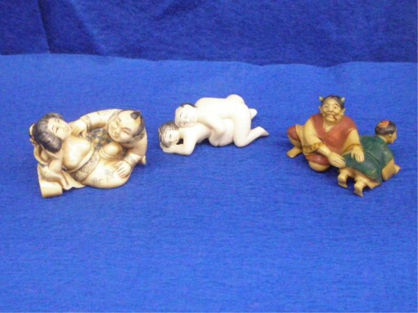 Three Ivory Erotic Netsuke's: Three Ivory Erotic Netsuke's, L 46 mm polychrome Oni spanking an old lady, L 51 mm nude loving couple & L 47 mm polychrome semi nude geisha with client; 2 signed; 20th c. [40]. No International Shippi