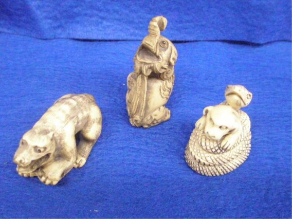 Three Ivory Netsuke's: Three ivory netsuke's, H 55 mm elephant, H 42 mm snaked coiled around dog, L 53 mm bear with skull; 2 signed; 20th c. [6]. No International Shipping