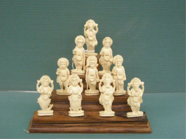 Ten Carved Ivory Buddhist Deities On Teakwood: Ten Carved Ivory Buddhist Deities On Teakwood stepped platform, figure heights approximately 55 mm, mid 20th c. [27]. No International Shipping