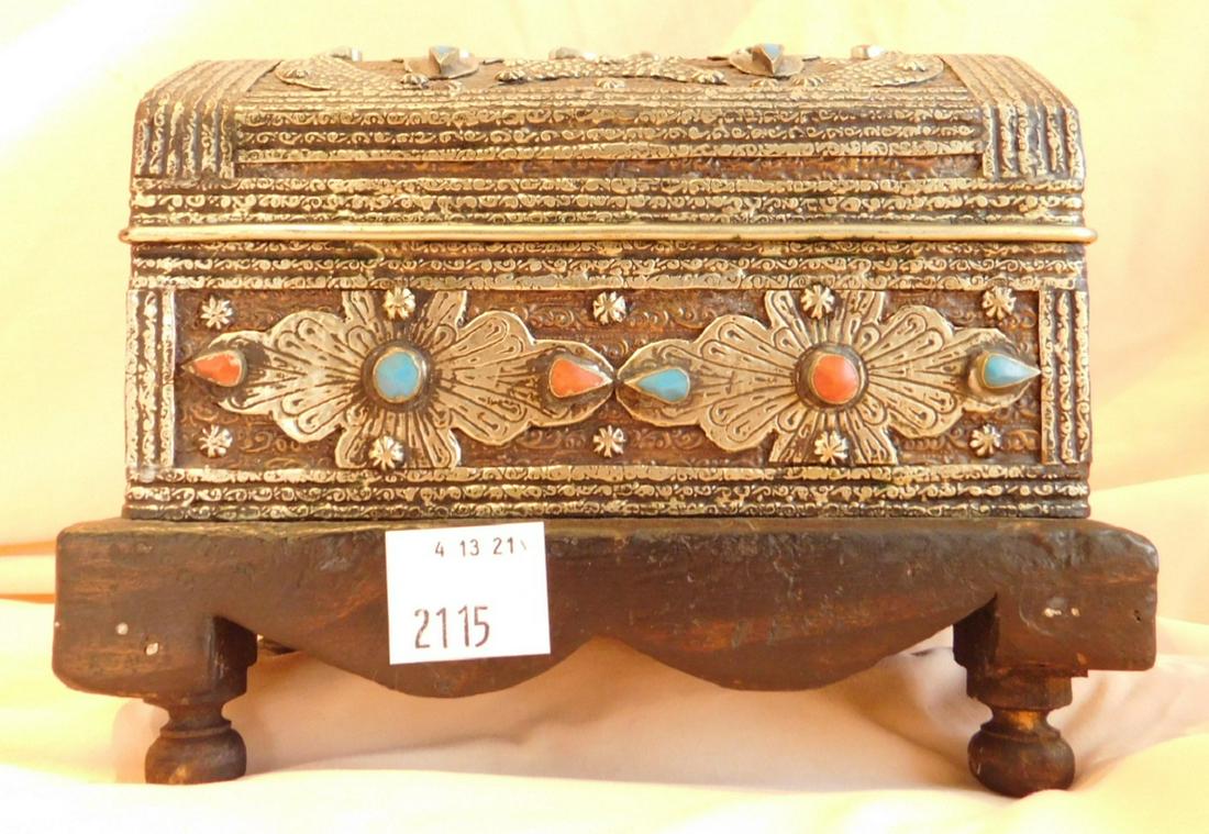 Persian Style Jewel Cabinet: Persian Style Jewel Cabinet, silvered metal, hinged dome lid, bezel set coral and turquoise stones, four wood foot base, red velour interior, 5: x 8 1/2" x 6 3/4". Condition; minor wear to wood base