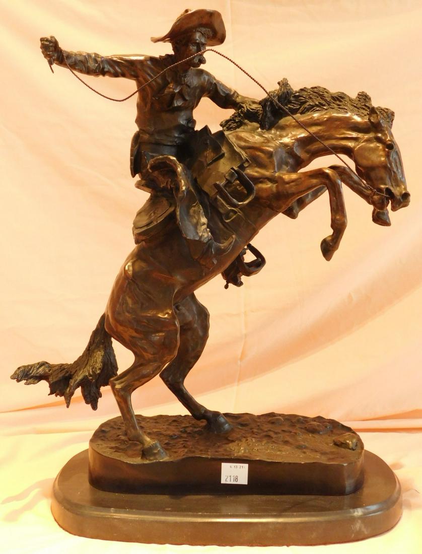 Frederic Remington Bronze Sculpture: Frederic Remington bronze sculpture, Bronco Buster, with black marble base, signed recast, 22" h. Condition; very good