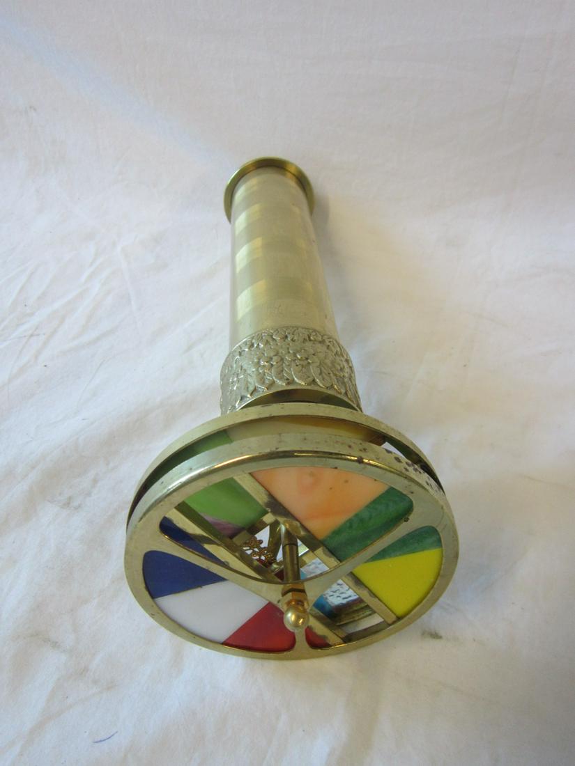 12" Brass Double Wheel Kaleidoscope: 12" Brass Double Wheel Kaleidoscope, 4 1/4' d, wheels with stained glass and jewels, embossed eyepiece and collar. No stand. [10] CONDITION: Used, scratches and pitting on tube.