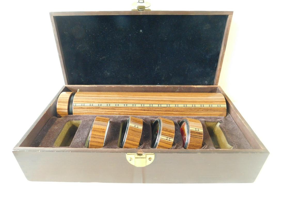 Mark & Carol Reynolds Kaleidoscope In Box: Mark & Carol Reynolds Kaleidoscope In Box, with five cases total, signed and dated 1984. Cases have liquid, seashells and stones, 14 1/2" x 8 1/2" x 4 1/2", box measurements. [2] CONDITION: Box has we