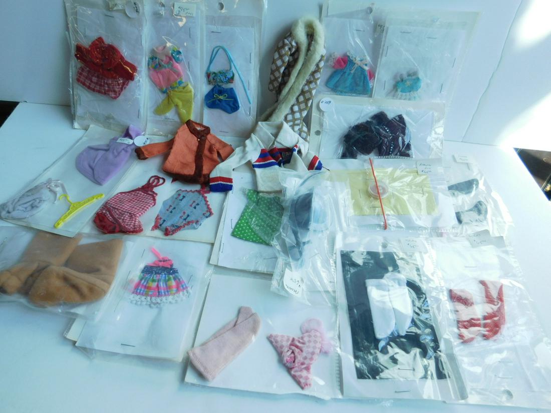 Barbie & Other Clothing: Barbie and Other Clothing includes: fourteen assorted Barbie and other outfits; Helmet and Sword, Barbie ink pad, three pairs of socks and lion paw socks, and a Bionic Woman jacket, etc. CONDITION: Ve