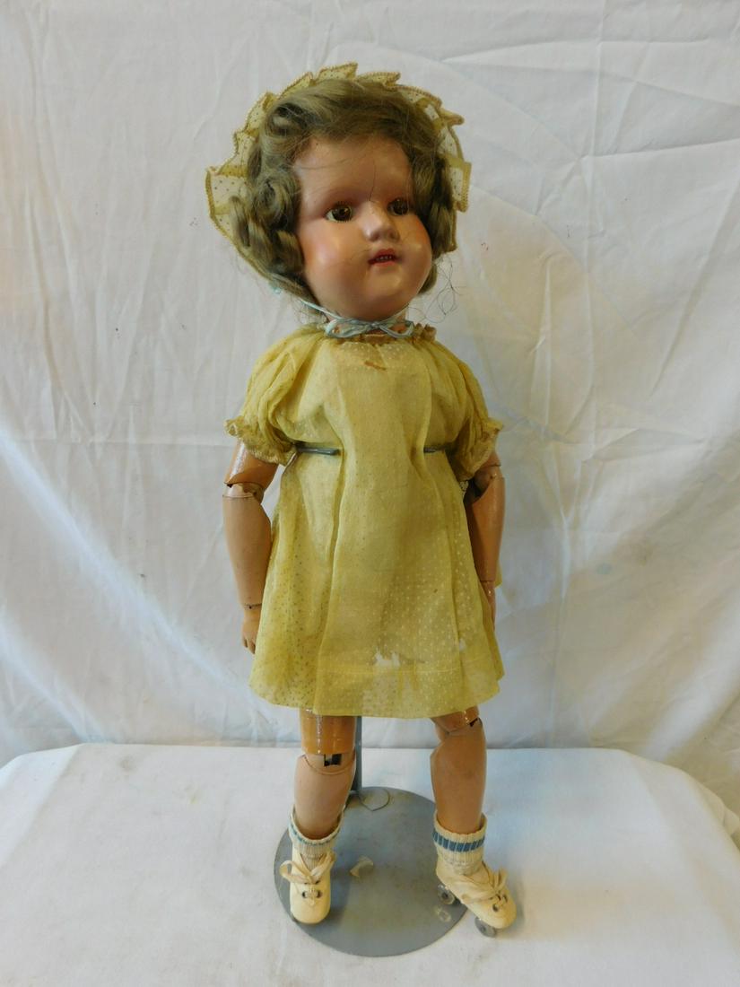 Schoenhut Wood Roller Skating Doll: Schoenhut 20" Wood Roller Skating Doll, wood, spring jointed, painted eyes and mouth with teeth, blond wig, yellow dress, bonnet and undergarments, socks and roller skates. CONDITION: Paint cracks on