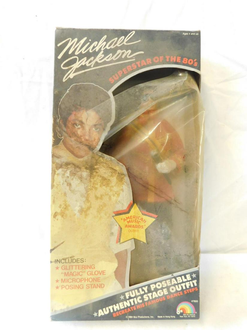 Michael Jackson Doll: Michael Jackson Doll by MJM Productions, 1984, original box #7800, box 14" x 7" x 2 3/4". CONDITION: Doll like new, still in original strappings on interior board. Box exterior dirty and soiled.