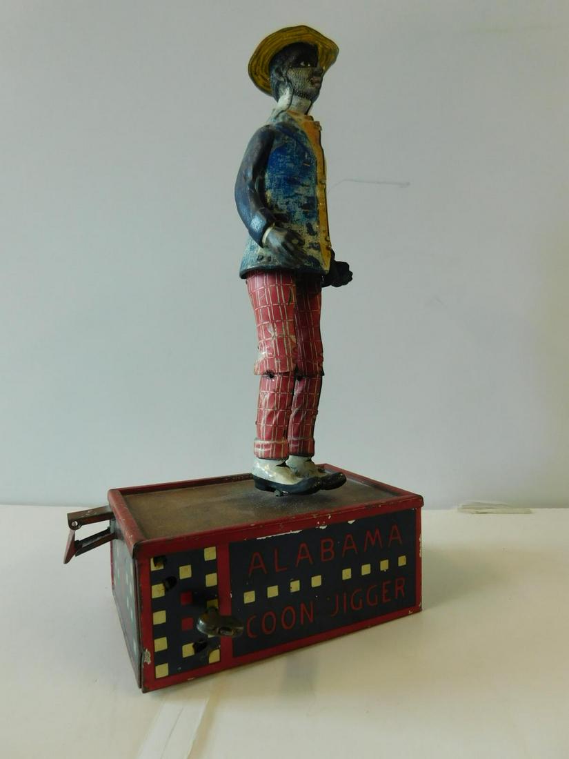 Alabama Coon Jigger Toy: Alabama Coon Jigger Toy by Lehman, Germany, No. 685, last patent 1912, lithographed tin, key wind, height 10 1/2". CONDITION: Good, working cond., some color fading to face and jacket, few scratches a
