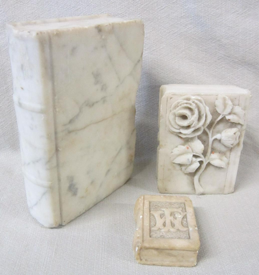 Marble Bookends & Paperweight: Marble Bookends and Paperweight, all book form, two bookends, smaller with raised flowers, 4"h (marked Lizzie Kornbau on back) and larger with raised spine, 6", plus small paperweight with raised FW i