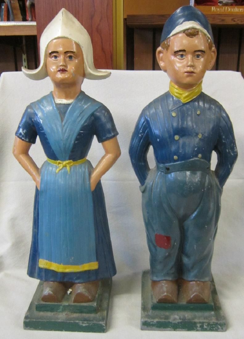 Large Aluminum Dutch Boy & Girl Door Stop: Large Aluminum Dutch Boy and Girl door stop, unmarked, hand painted with attached plinth bases, 20"h each. CONDITION: Minor paint loss, especially at bases.