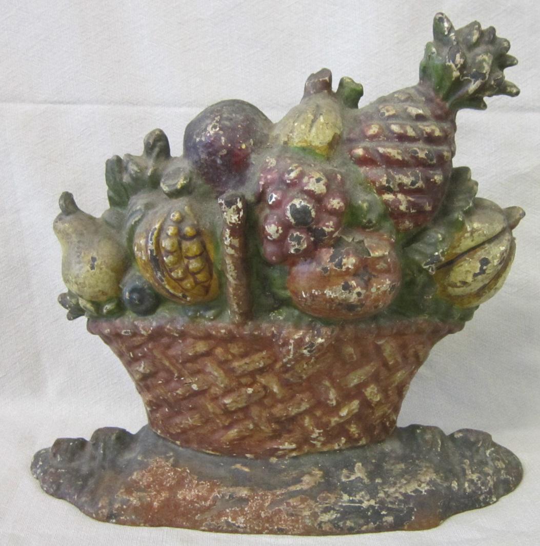 Vintage Cast Iron Door Stop: Vintage Cast Iron Door Stop, fruit basket, hand painted, no marks, 11 1/4"l x 9 3/4"h. CONDITION: Small areas of paint loss and some surface rust, especially at base.