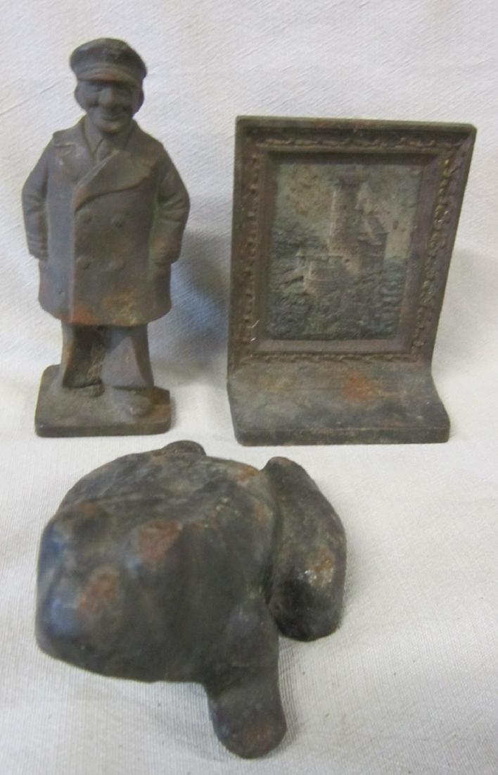 Cast Iron Doorstops & Bookend: Unusual Bradley & Hubbard picture frame bookend, Castle Liechtenstein (hand painted, relief), with B & H mark on back bottom. plus (2) doorstops - Sea Captain, 6 1/2" and Frog with phallic underneath,