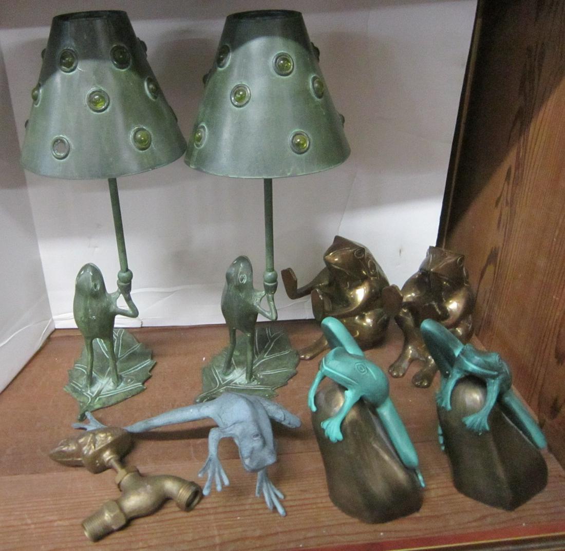 8 Brass Frog Collectibles: Eight Brass Frog Collectibles including: a pair of frog on Lily pad candle lamps with shades, glass ball accent, 16" h each, two pair of bookends, etched brass seated frogs, 6" and green patina frogs 