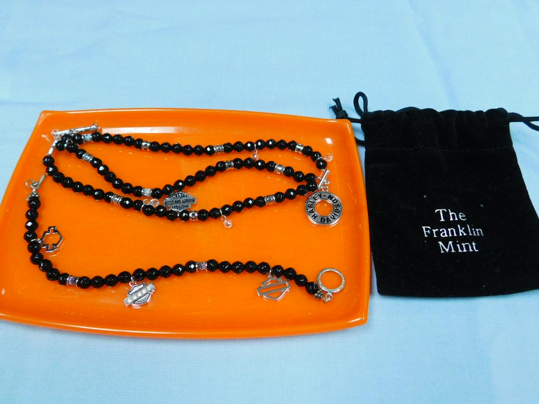 2 Piece Franklin Mint Harley Davidson Jewelry: Two piece Franklin Mint Harley Davidson Jewelry, sterling, black onyx and crystal single strand 18" bracelet with three charms. Triple strand 8" bracelet with one charm and five crystal drops. Toggle