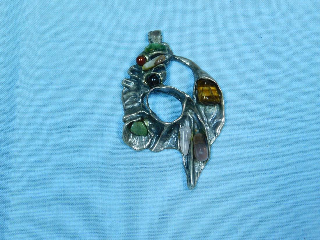 Silver Brutalist Biomorphic Pendant: Silver Brutalist Biomorphic Pendant, heavy unmarked silver handcrafted pendant with eight applied natural polished stones, quartz, onyx, tiger eye, etc. 3 1/2" x 2 1/4", 2.15 ozt. CONDITION: Very fine