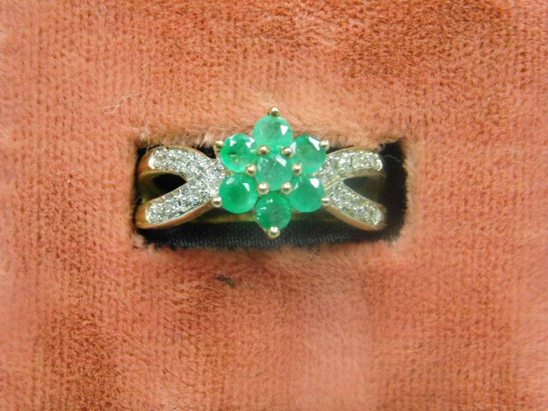 10k YG Ring w/Emeralds & Diamonds: 10k YG Ring with Emeralds and Diamonds, Florette w/seven emeralds and side accent diamonds. 2 DWT. [7] CONDITION: Very good, preowned.